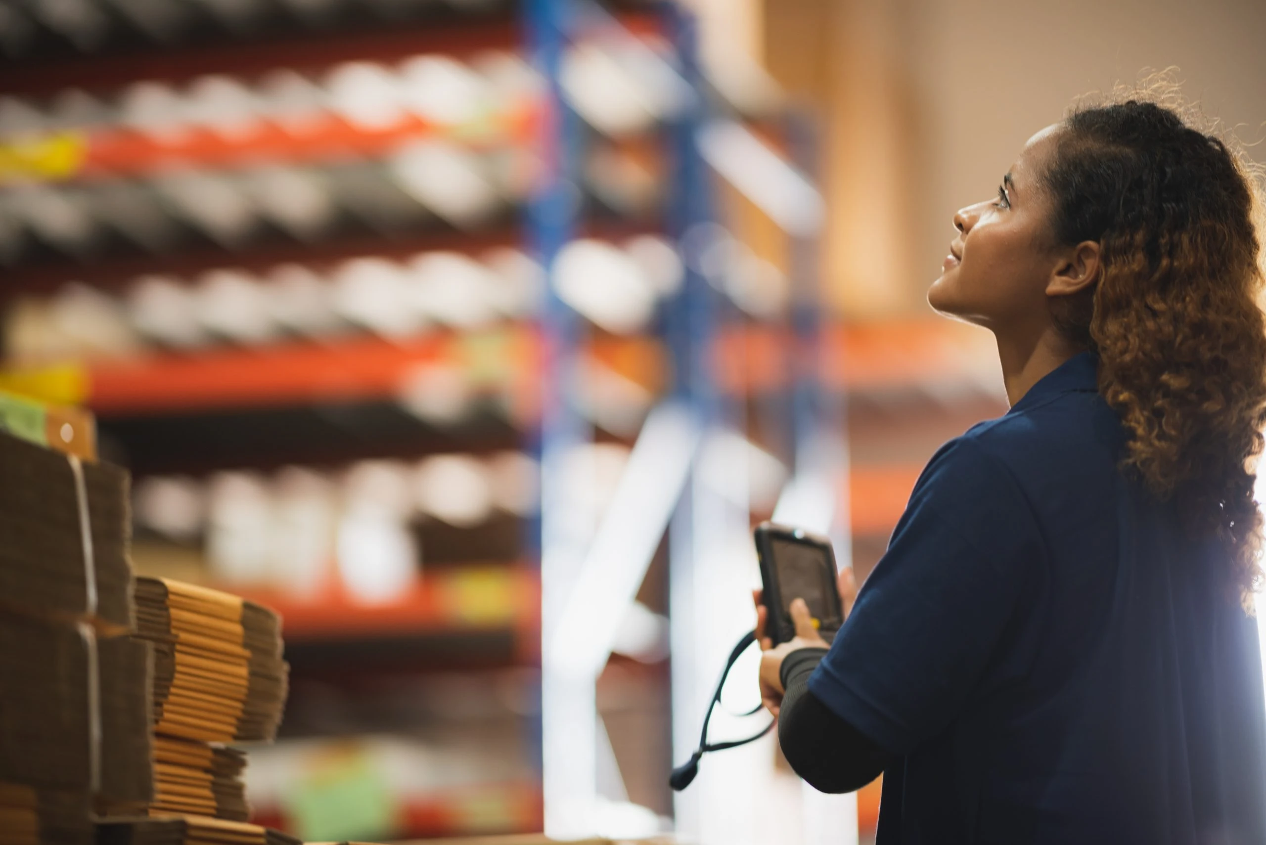 warehouse worker using bar code scanner to analyze newly arrived goods for further placement in storage department, logistic working at warehouse.